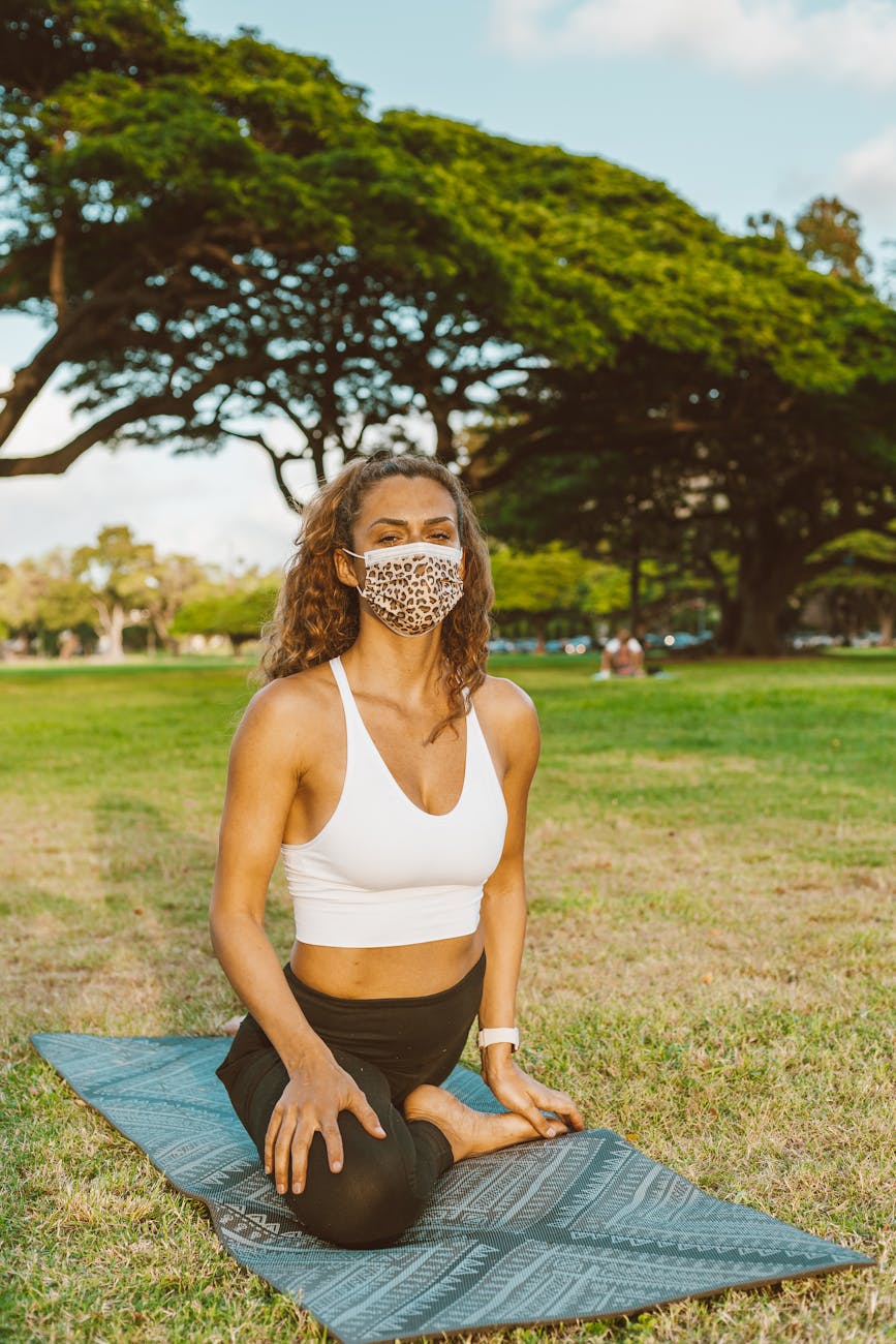 Woman in a sitting yoga pose looking serene.